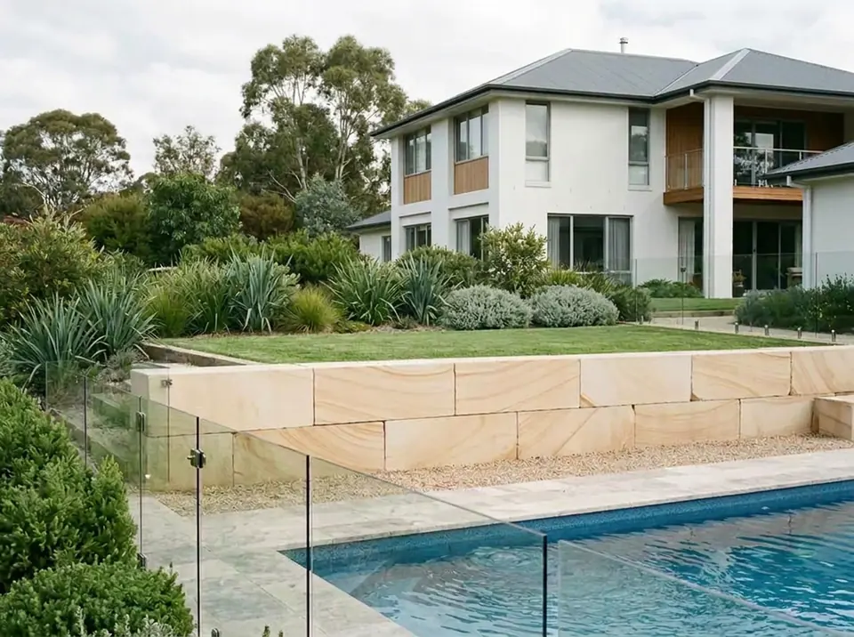An A grade sawn sandstone log retaining wall beside a pool in Canberra